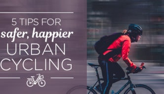 cyclist riding past blurred city buildings - tips for urban cycling
