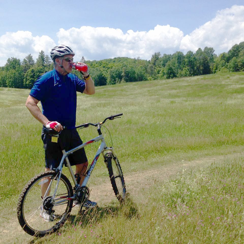 Celebrating cycling dads on father's day – Photo of Rob taking a breather while mountain biking at on Vermont's Kingdom trails