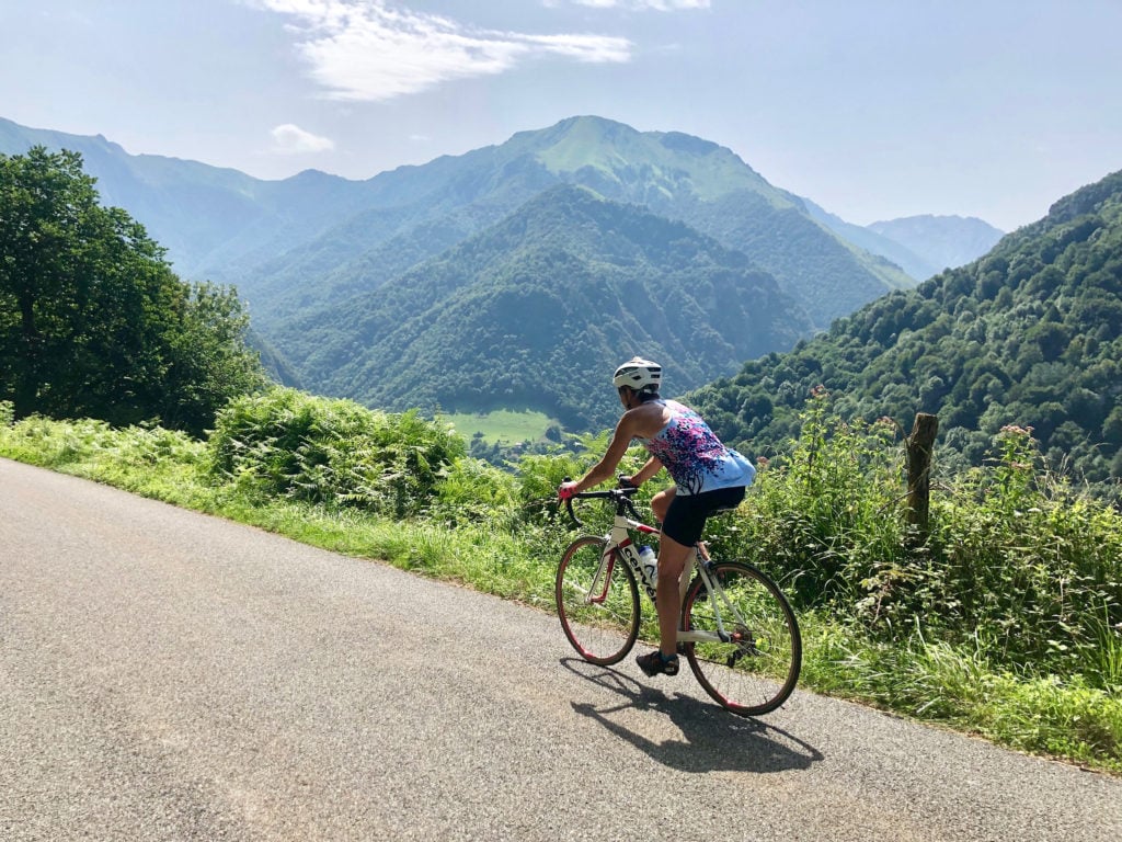 Cycling in the mountains in the south of France, with a view of dramatic mountains in the distance