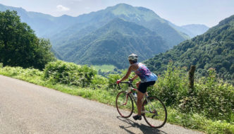 Cycling in the mountains in the south of France, with a view of dramatic mountains in the distance