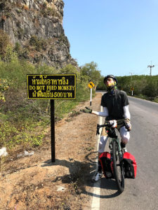 Riding through Khao Sam Roi Yod National Park, Thailand. Paused by a sign reading Do Not Feed The Monkeys.