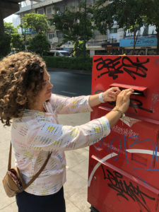 Mailing postcards in a post box, Bangkok, on our cycling tour inThailand