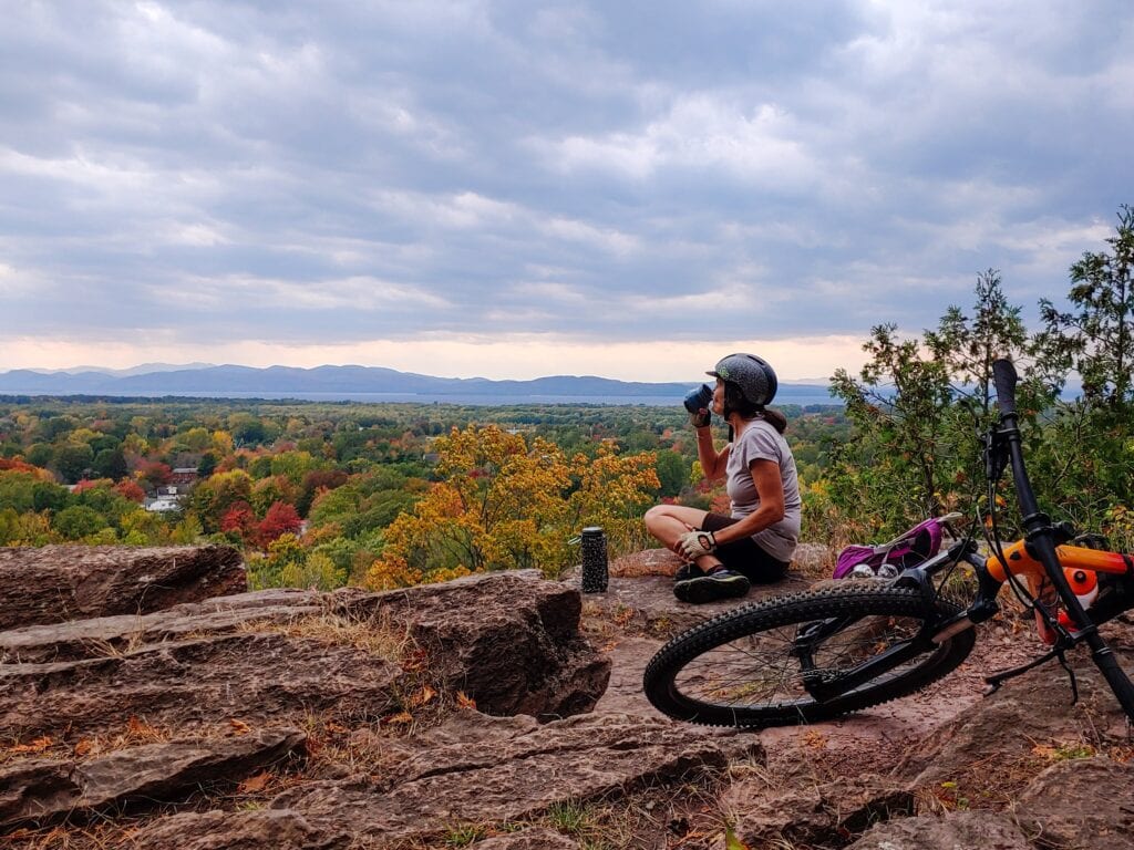 Enjoying a break with a hilltop view on a mountain bike ride in Vermont.