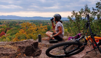 Enjoying a hilltop view on a mountain bike ride in Vermont